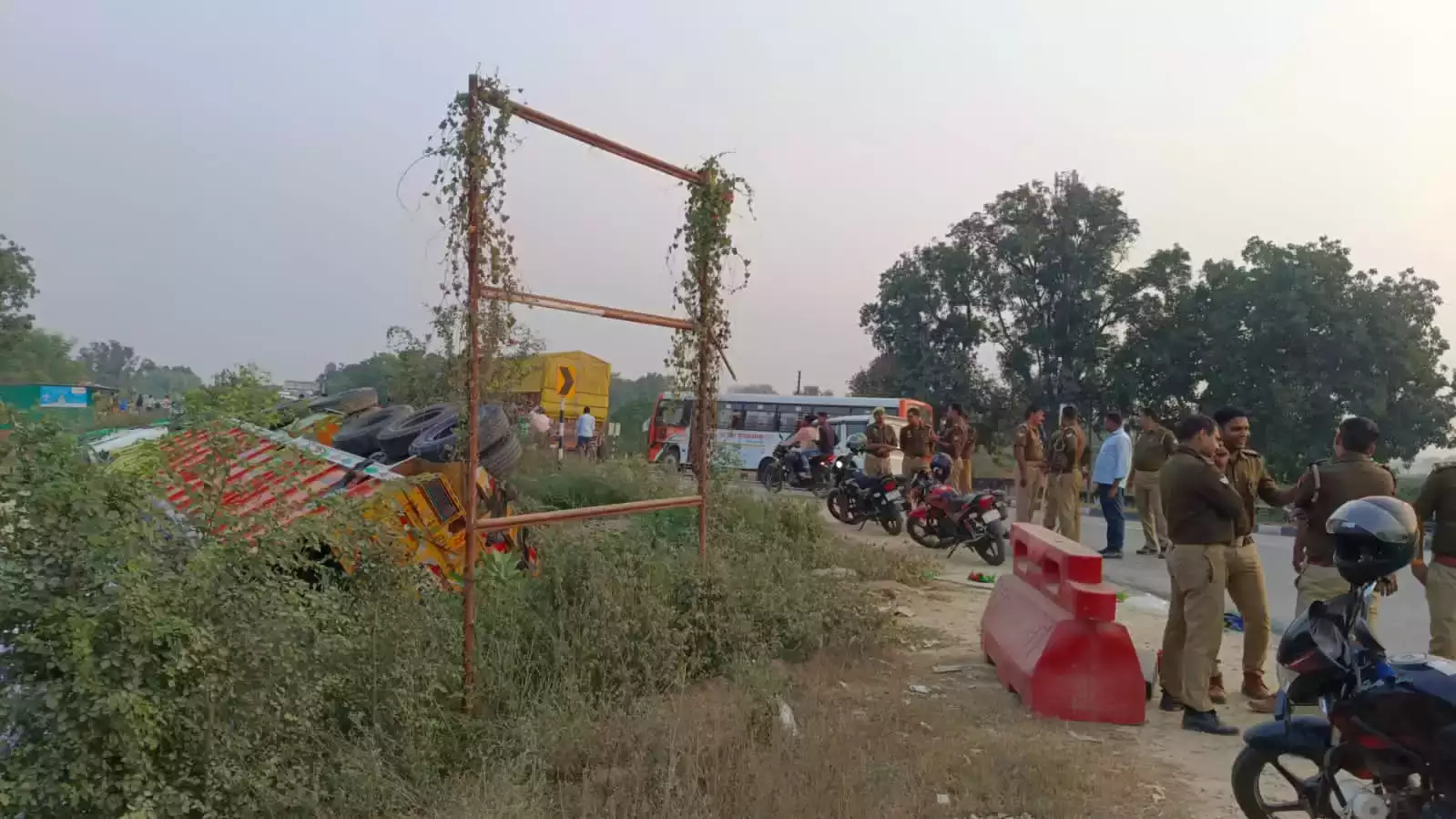 a group of people standing next to a crash